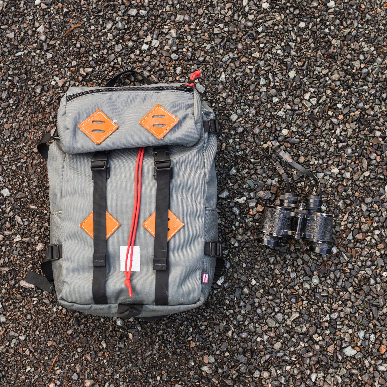 backpack-binoculars-gravel